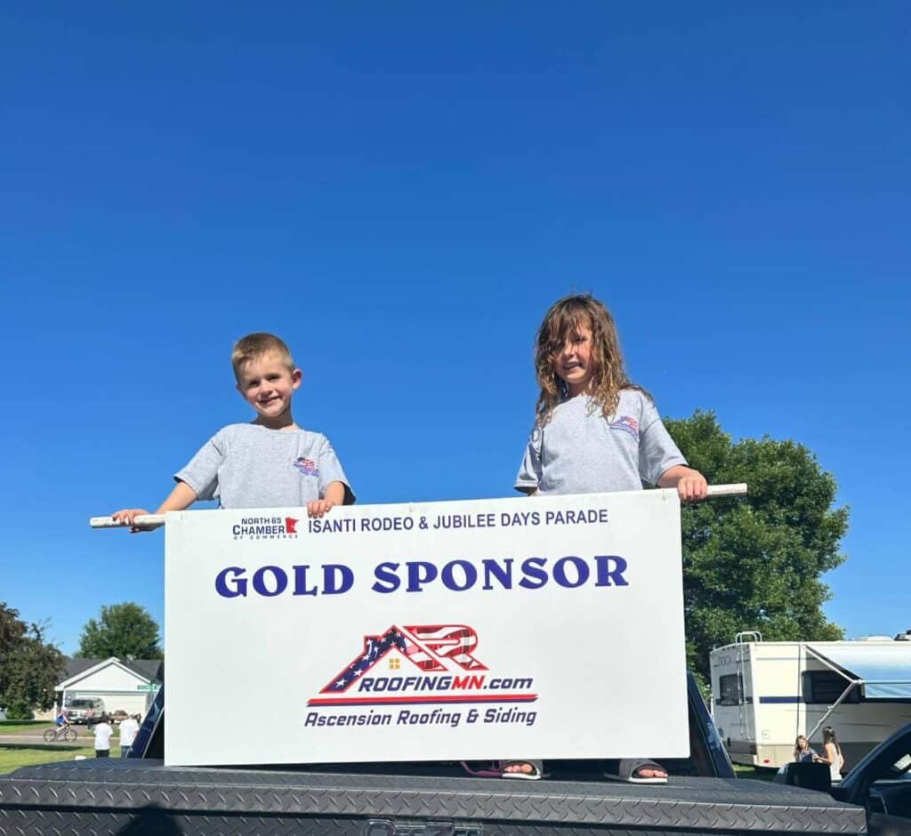 a photo of a two child holding a banner about gold sponsor