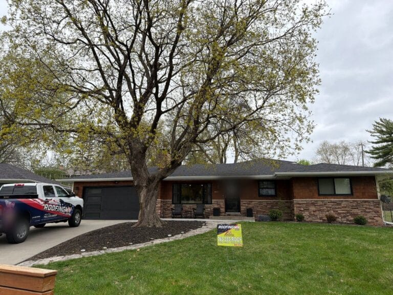 Ascension Roofing & Siding truck and yard sign at a finished roof replacement in Edina